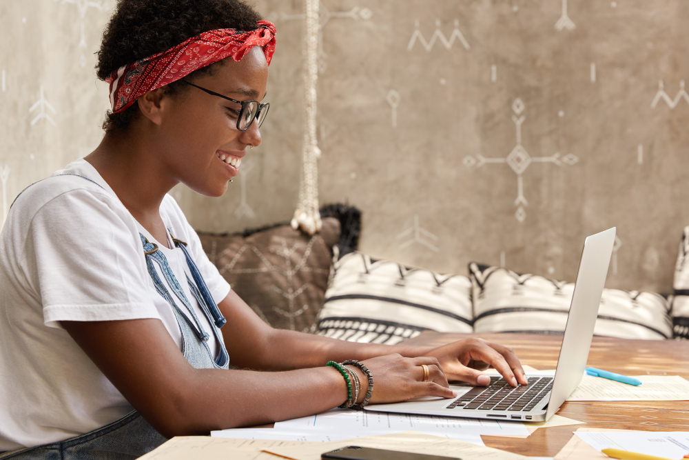Black lady taking an exam and smiling